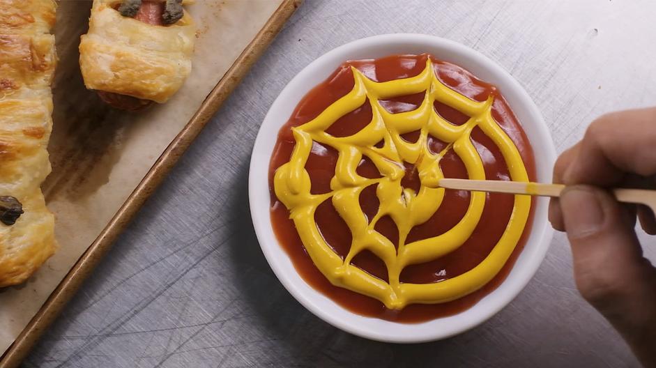 Mummy Dogs Recipe: Use a toothpick to draw even lines to the center of the circle to create a web.