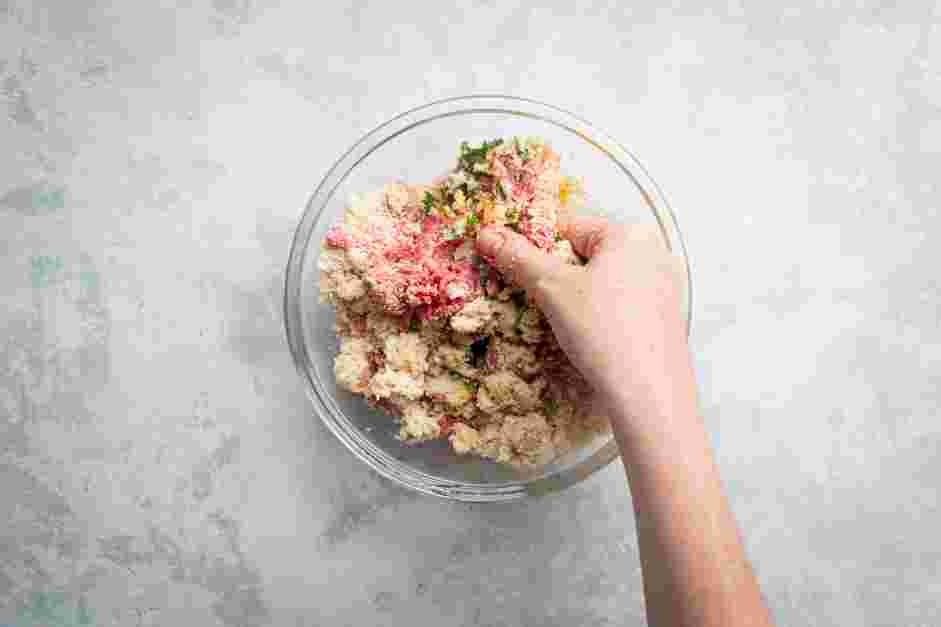 Meatball Marinara Recipe: In a large mixing bowl, mix the milk-soaked bread, ground beef, eggs, Parmesan, breadcrumbs, garlic, salt and pepper by hand.