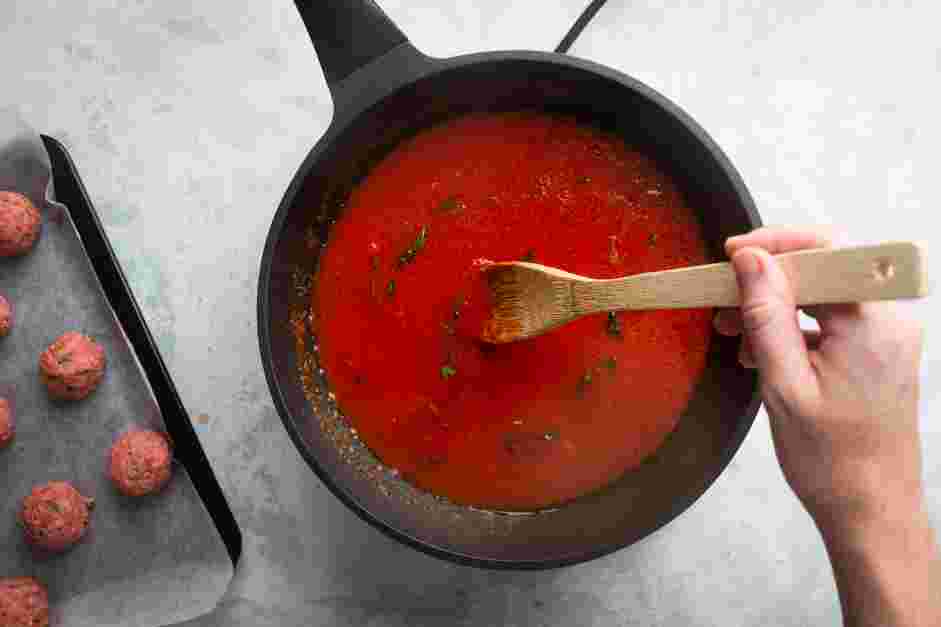 Meatball Marinara Recipe: Add the crushed tomatoes, basil, water, salt and pepper.