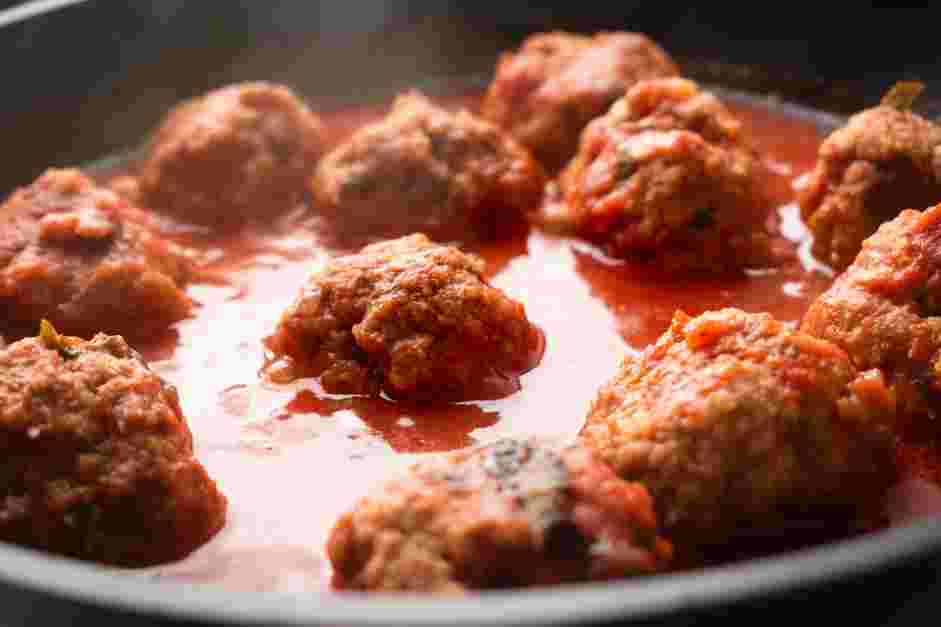 Meatball Marinara Recipe: Uncover the pan and use tongs to flip the meatballs.