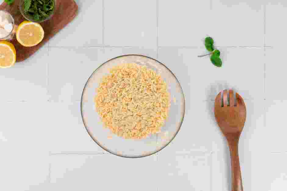 Lemon Orzo Recipe: Drain the cooked orzo into a medium mixing bowl.