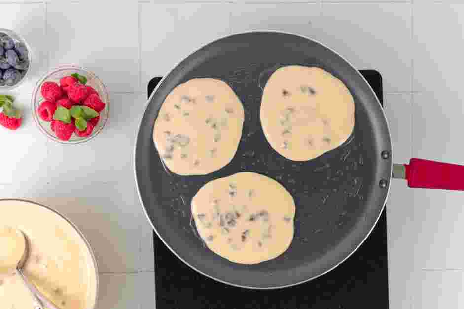 Chocolate Chip Pancake Recipe: Ladle &frac14; cup of batter onto the griddle and cook until bubbles form on top of the pancake and the edges are set, about 2-3 minutes.