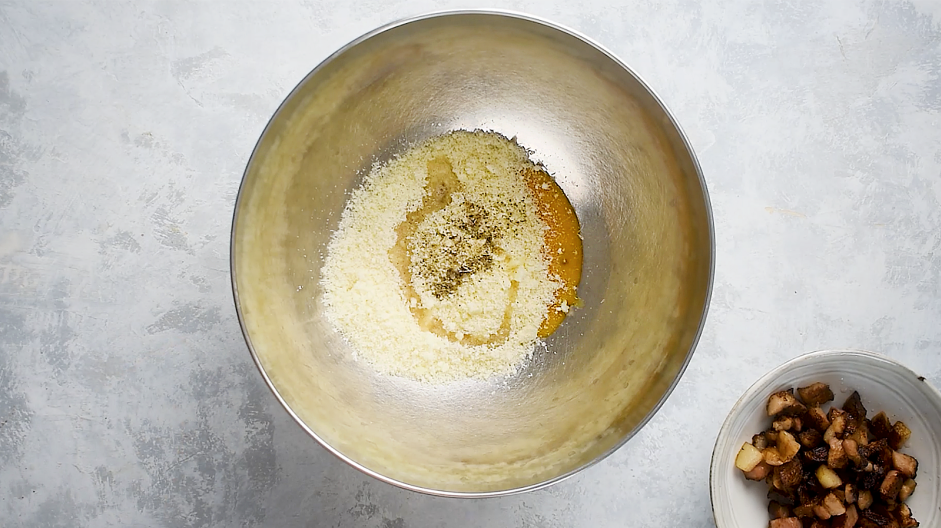 Traditional Carbonara Recipe: In a steel mixing bowl, mix the egg yolks, Parmesan, Pecorino Romano, 1 tablespoon of fat from the guanciale and pepper together.