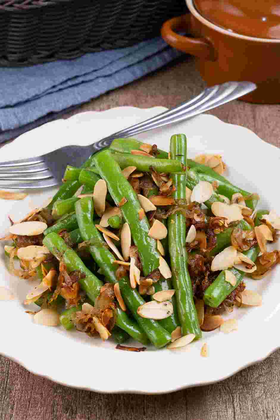 Green Bean Almondine Recipe: Plate the green beans and garnish the top with reserved almonds.