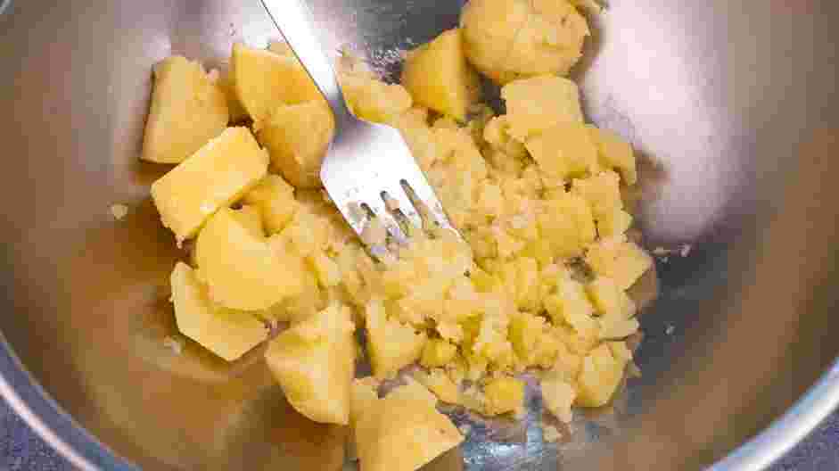 Italian Gnocchi Recipe: Mash the potatoes with a potato masher or a fork.