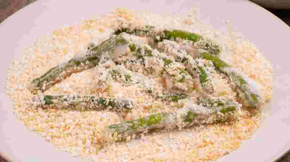 Green Bean Fries Recipe:
Let the excess egg white drip off and roll the green beans into the panko.