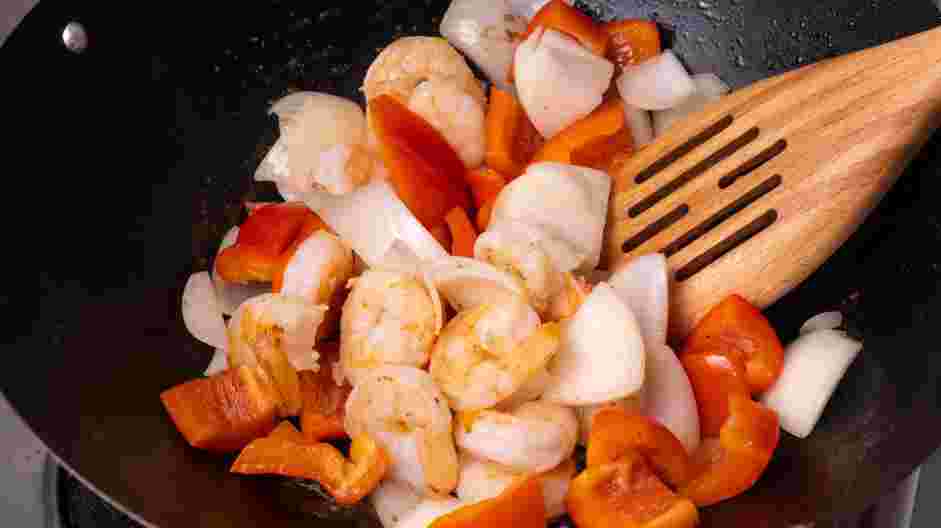 Sweet and Sour Shrimp Recipe: Add the shrimp, onions and peppers to the wok.