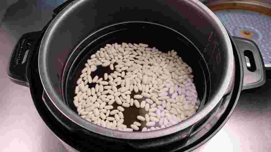 Instant Pot Baked Beans Recipe: In the bowl of an Instant Pot, add the dried beans and water.