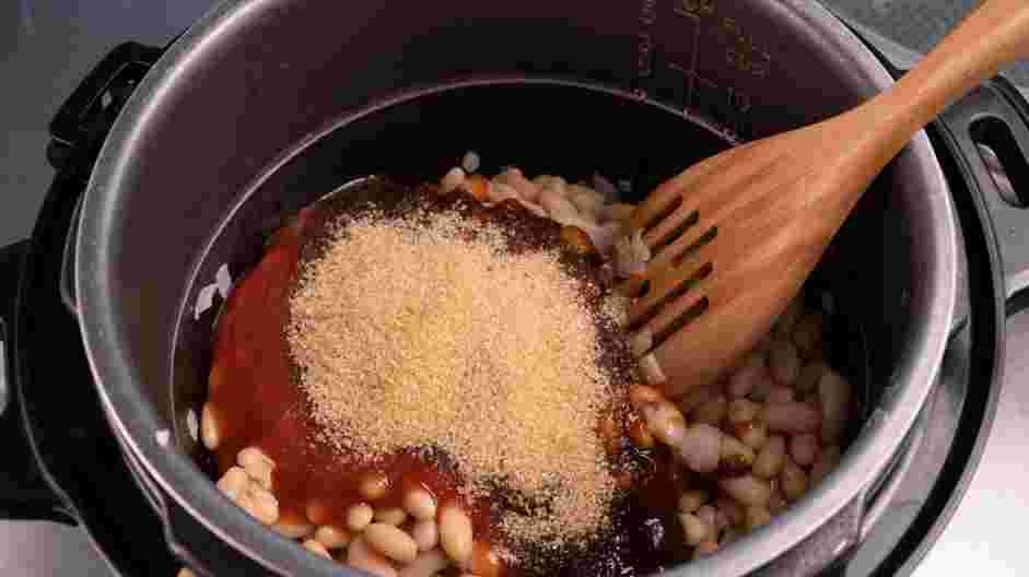 Instant Pot Baked Beans Recipe: Stir in the reserved beans, ketchup, barbecue sauce, brown sugar, chicken stock and liquid smoke.