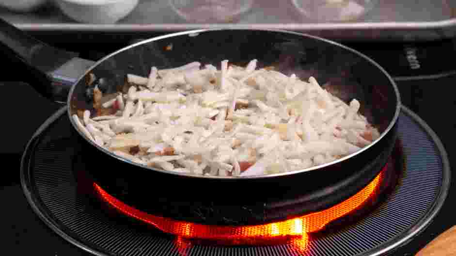 Breakfast Skillet Recipe: Add the shredded potatoes and cook, stirring occasionally, until browned, about 5 minutes.