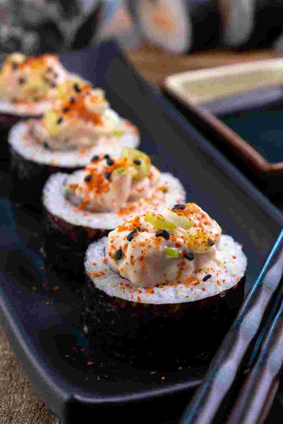 Spicy Salmon Roll Recipe: Slice each sushi roll into six pieces and top with more of the spicy salmon filling.