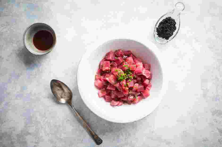 Tuna Tartare Recipe: In a large mixing bowl, combine the diced tuna, chives, ponzu, Sriracha and mayo.