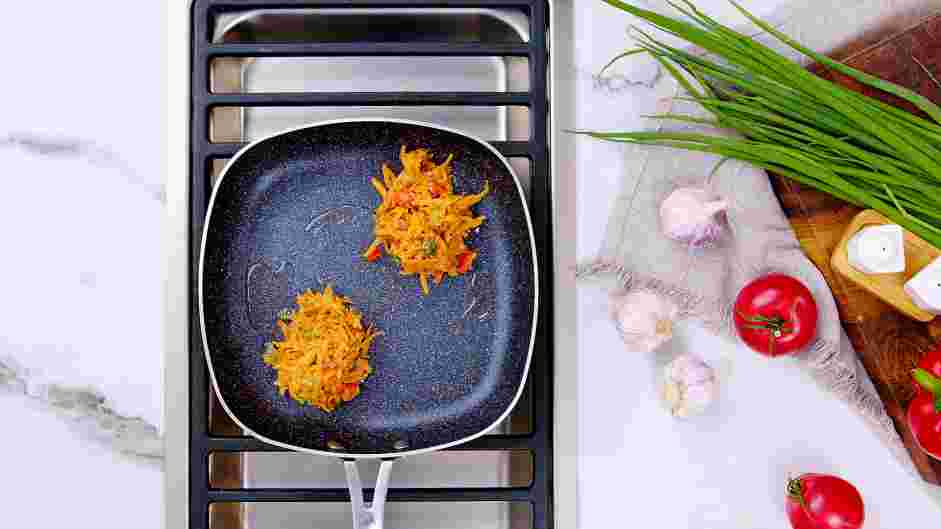 Sweet Potato Hash Browns Recipe: Heat &frac12; tablespoon of vegetable oil in a 12 or 14-inch skillet over medium-high heat.