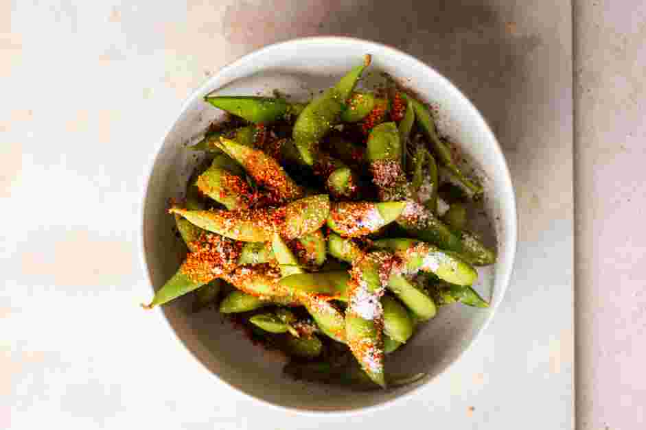 Spicy Edamame Recipe: While the edamame is still hot, add the salt, sugar and the ichimi togarashi.