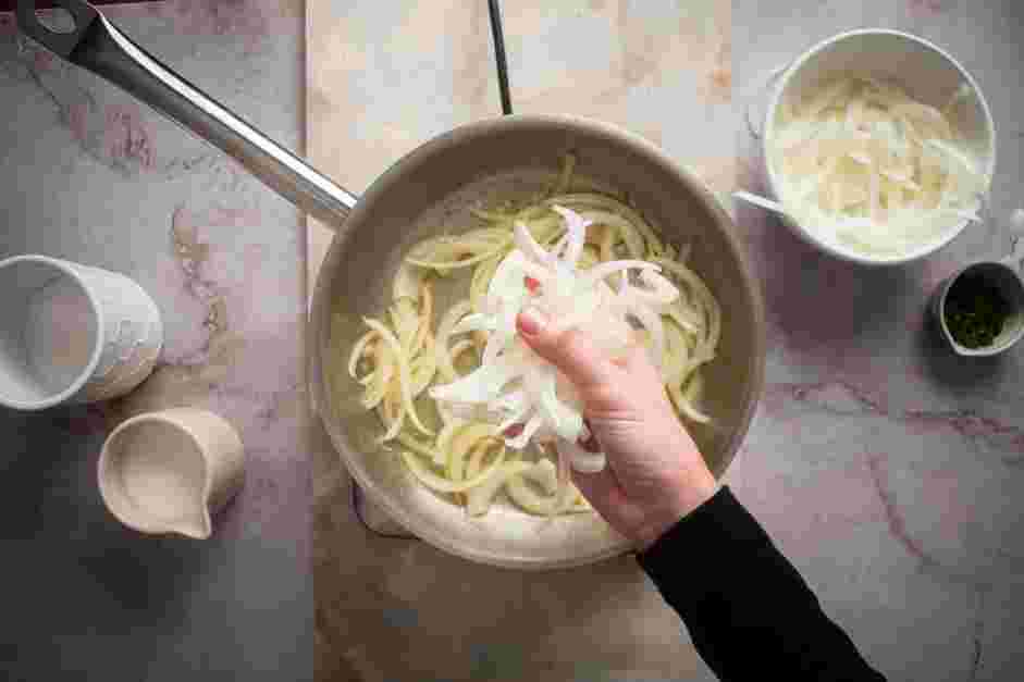 Caramelized Onion Dip Recipe: Add the olive oil and a handful of the sliced onions.