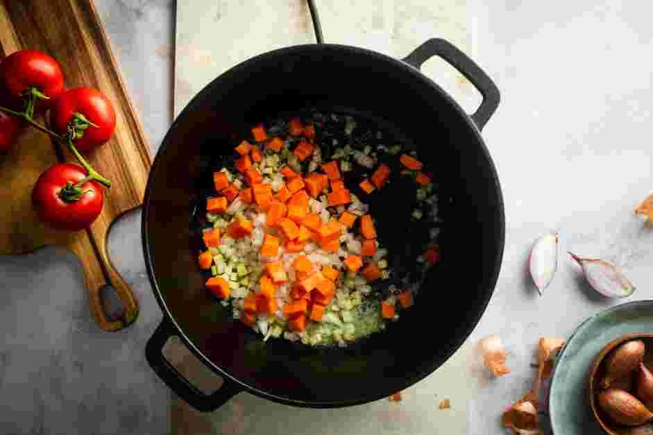 Creamy Tomato Soup Recipe: In a large saucepan over low heat, add the butter, shallots, onion, carrots and celery.