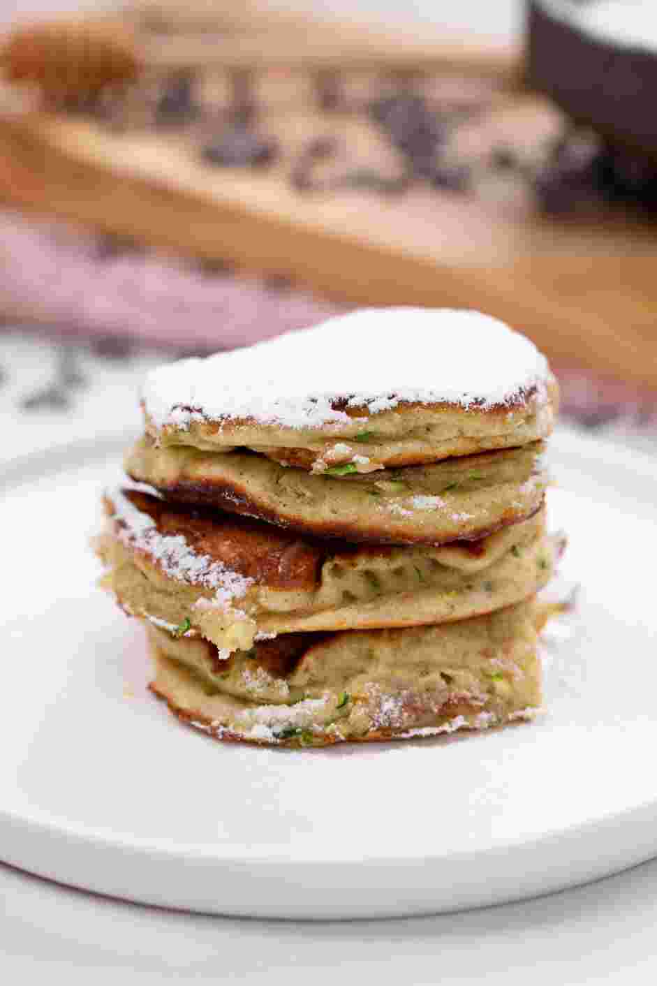 Zucchini Pancakes Recipe: Top the pancakes with powdered sugar and maple syrup.