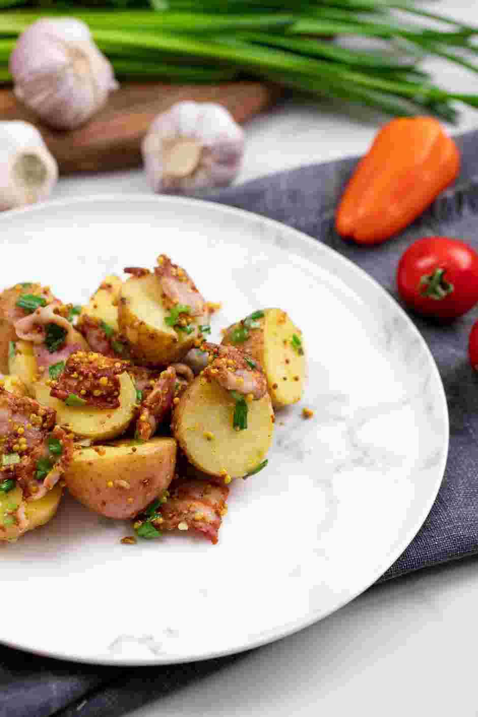 Potato Salad with Bacon Recipe: Before serving, toss the potatoes with a spoon and add more of the reserved vinaigrette, if needed.