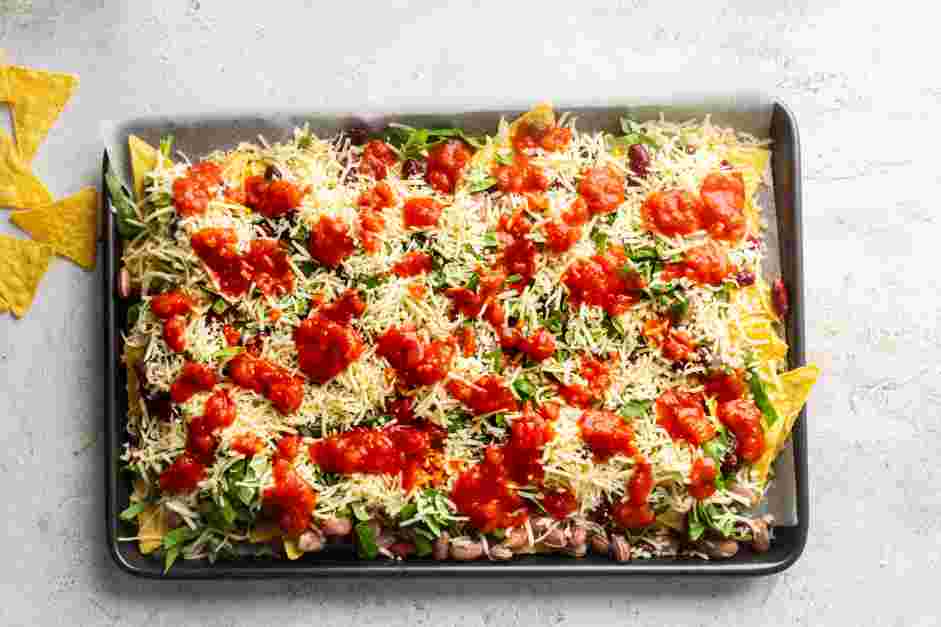 Sheet Pan Nachos Recipe: Top the spinach with the salsa.