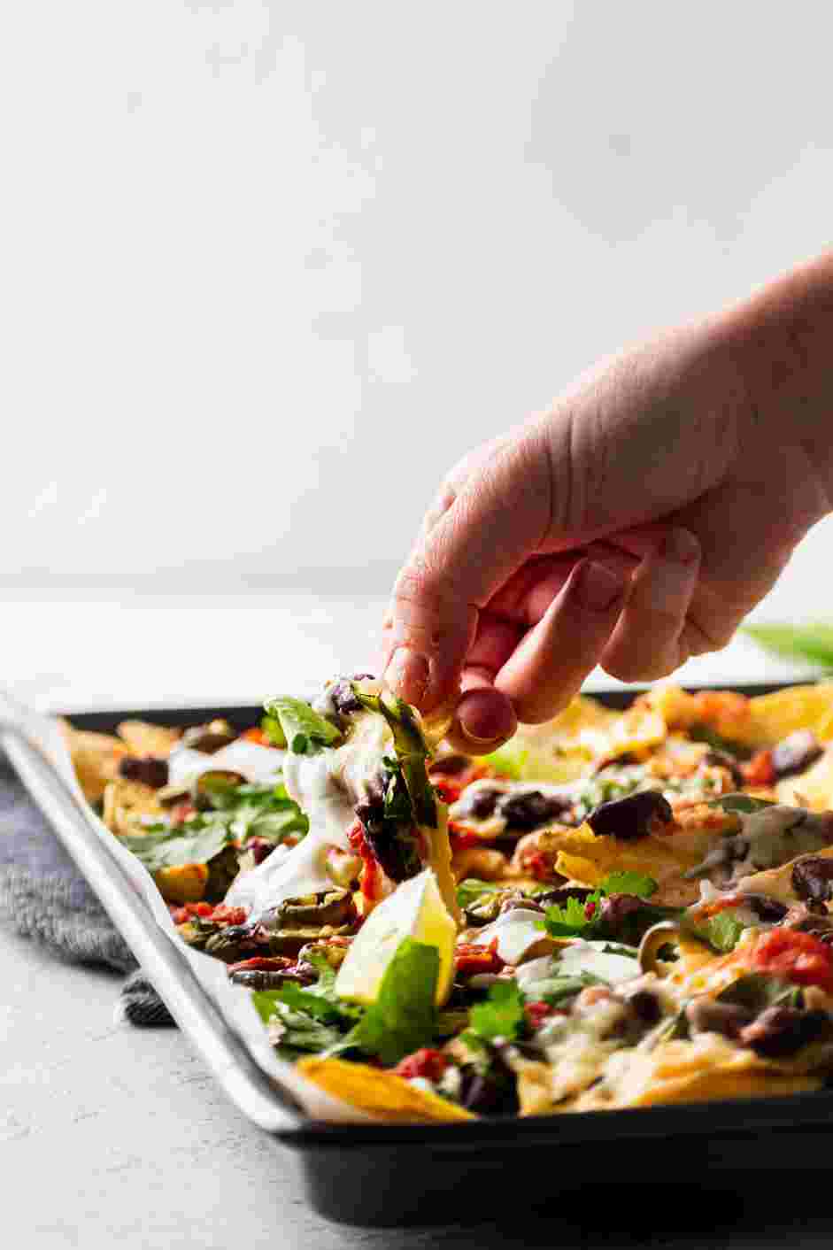 Sheet Pan Nachos Recipe:
Shake hot sauce over the nachos to taste.