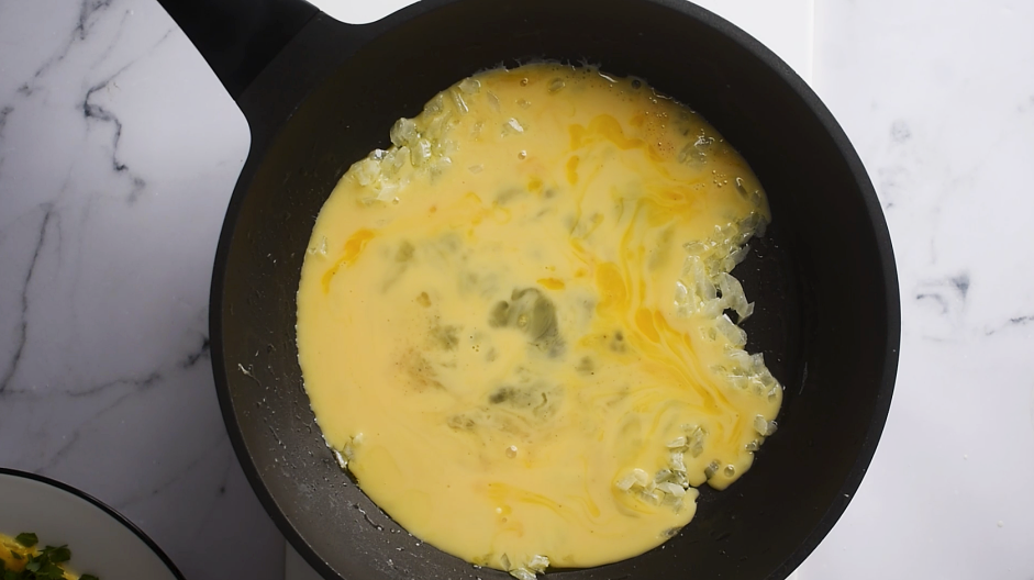 Spinach Omelette Recipe: Pour half of the egg mixture over the remaining onions.