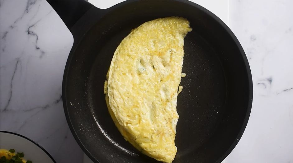 Spinach Omelette Recipe:
Loosen the edges of the omelette and use a spatula to fold the omelette in half.