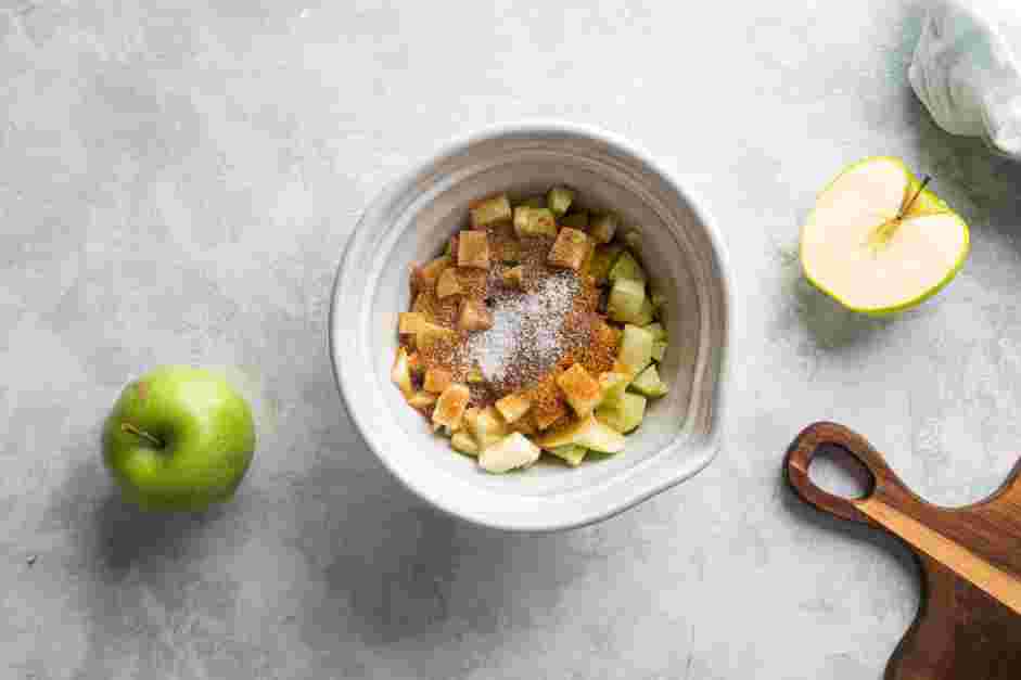 Mini Apple Pies Recipe: In a large bowl, mix the apples with brown sugar, cardamom and salt.