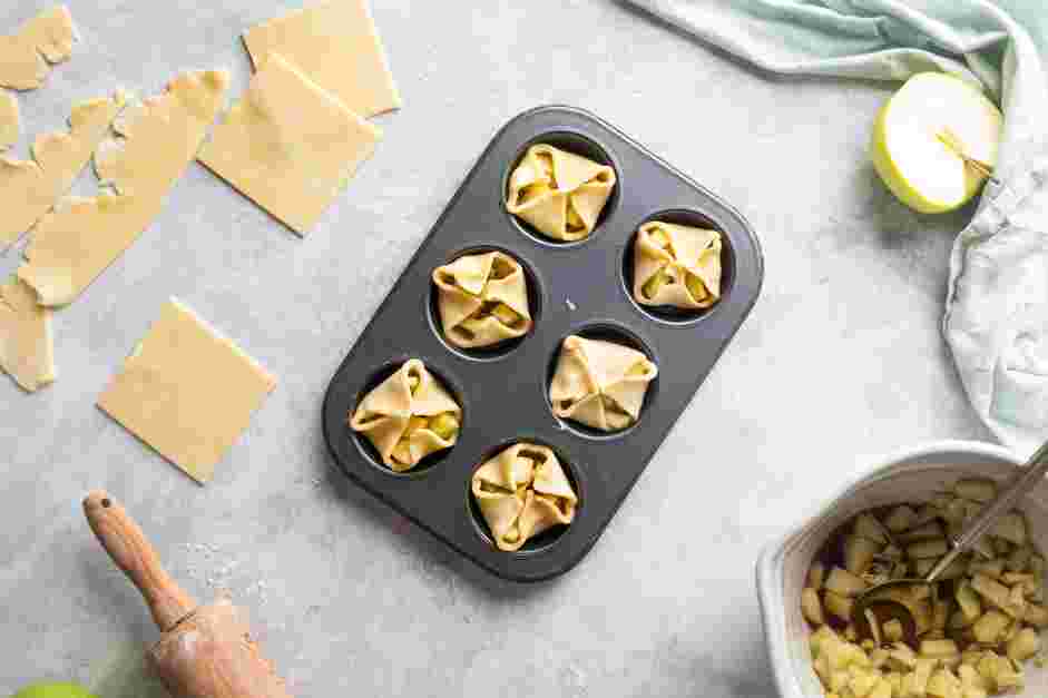 Mini Apple Pies Recipe: Fold the corners of the dough over the filling.