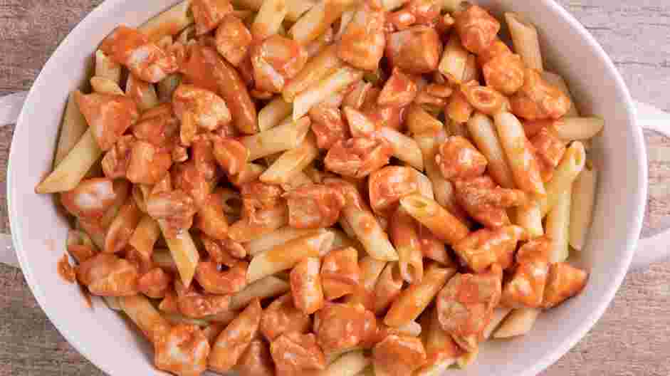 Buffalo Chicken Pasta Recipe: Transfer the coated chicken and the remaining sauce to the roasting pan with the pasta.