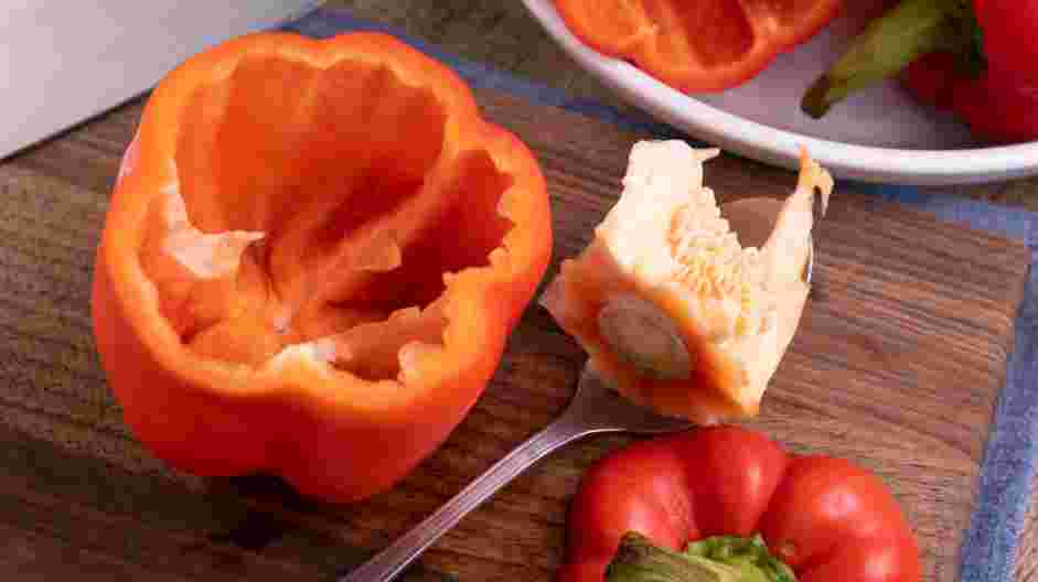 Sausage Stuffed Peppers Recipe: Using a spoon, remove the seeds and the membranes of the bell peppers.