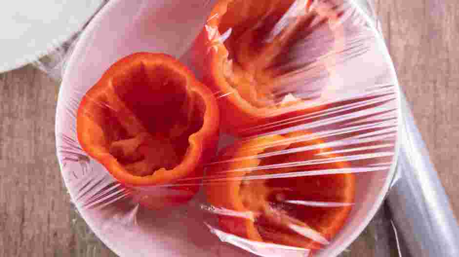 Sausage Stuffed Peppers Recipe: In a microwave-safe bowl filled with &frac12; cup of water, place the seeded bell peppers and cover with plastic wrap.