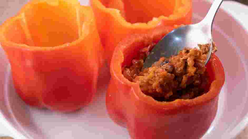 Sausage Stuffed Peppers Recipe: Fill the peppers with the sausage mixture and transfer them to a baking dish.