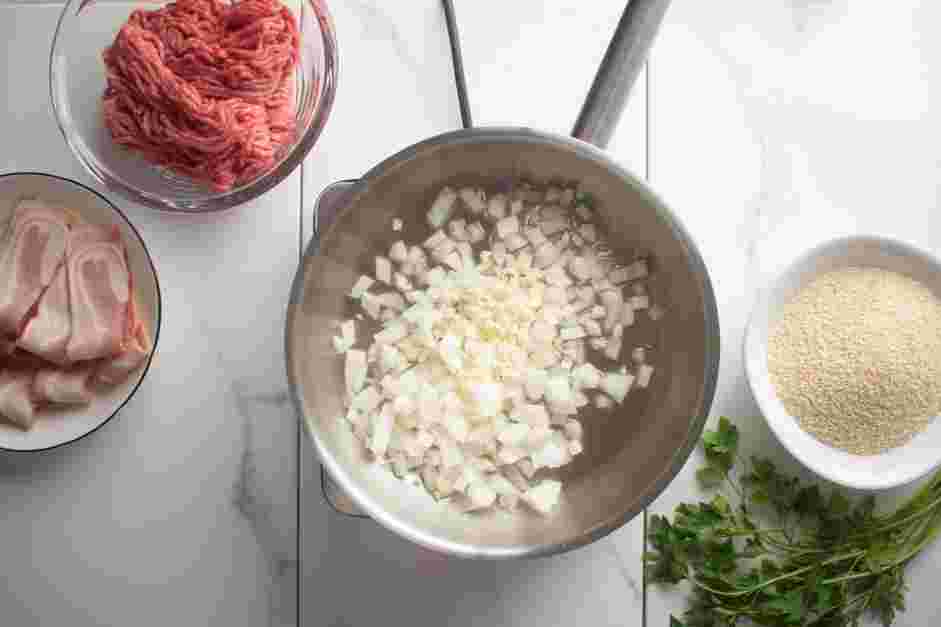 Bacon Wrapped Meatloaf Recipe:
In a small frying pan over medium-low heat, cook the onion and garlic until softened, about 5 minutes.