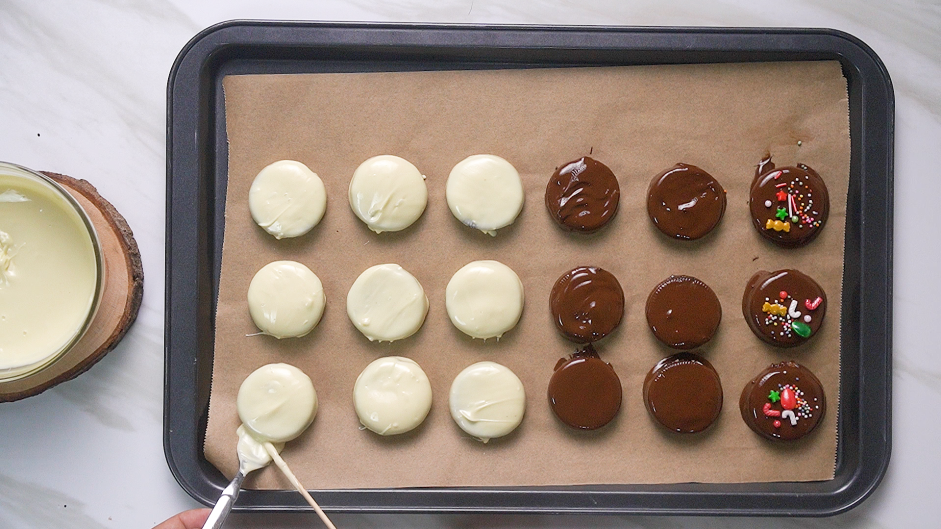 Chocolate Covered Oreos Recipe: Let the excess chocolate drip off before placing the chocolate dipped Oreo onto the prepared baking sheet.