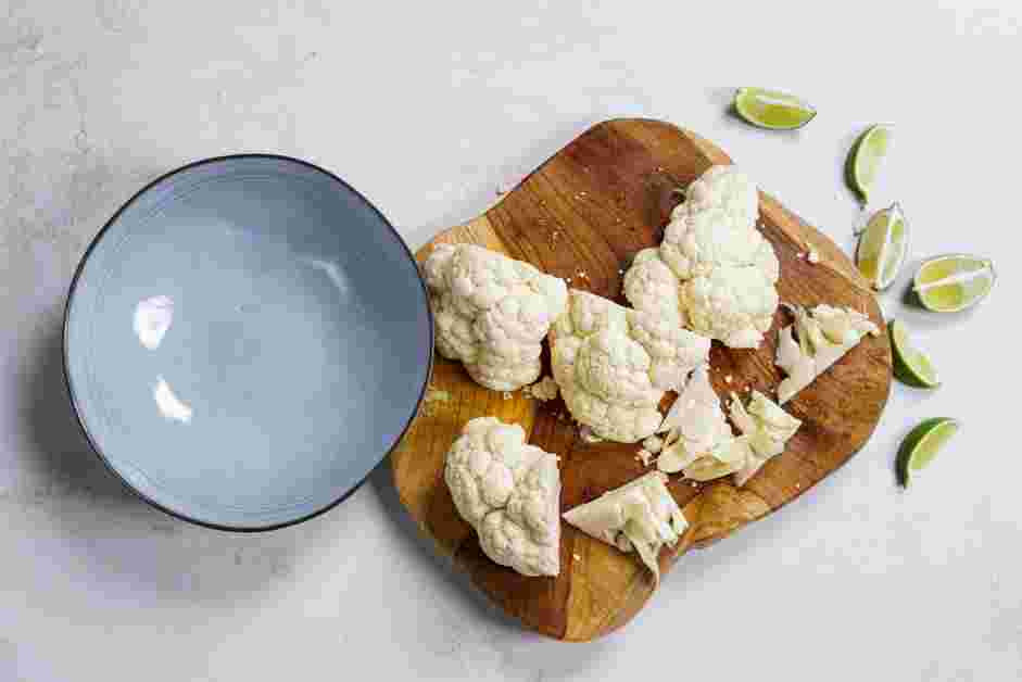 Cilantro Lime Cauliflower Rice Recipe: Quarter the head of the cauliflower and lay each quarter on its side and slice off the fibrous stems.