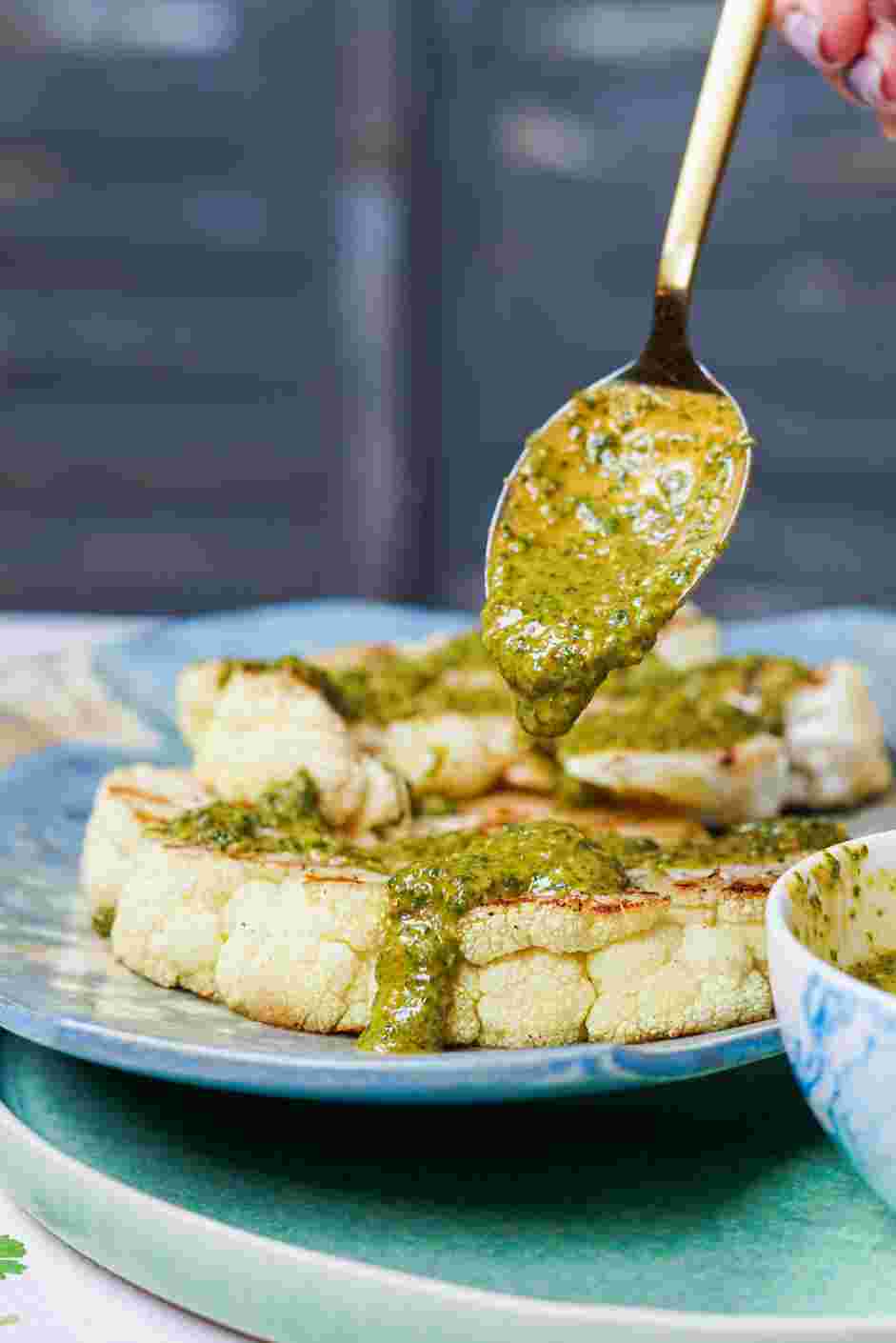 Grilled Cauliflower Steaks Recipe: Drizzle the cauliflower steaks with the chermoula sauce and enjoy!