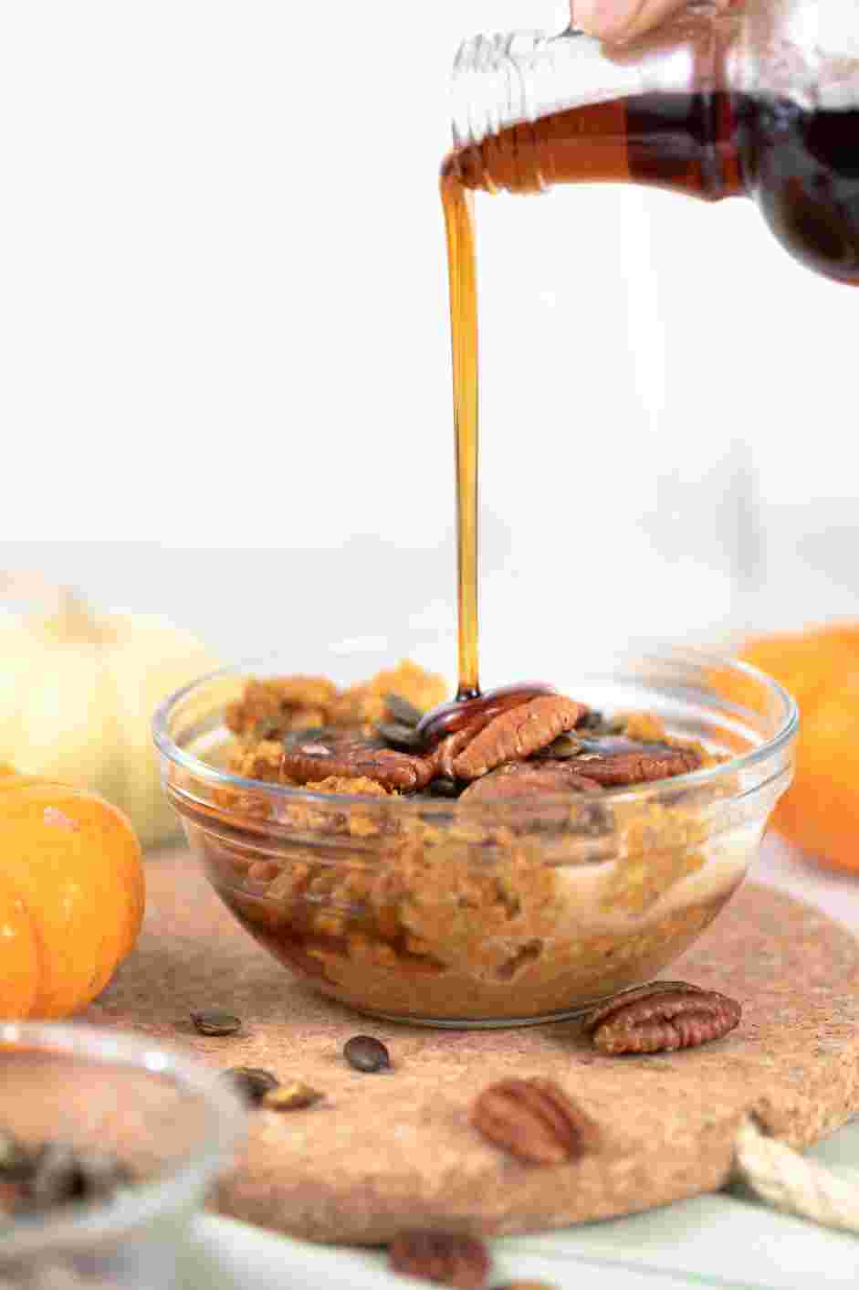 Pumpkin Oatmeal Recipe: Serve hot, topped with a splash of milk, maple syrup, toasted pumpkin seeds and pecans.