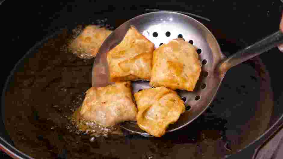 Chicken Wonton Recipe: Fry the wontons immediately in the hot vegetable oil until golden brown and crispy.