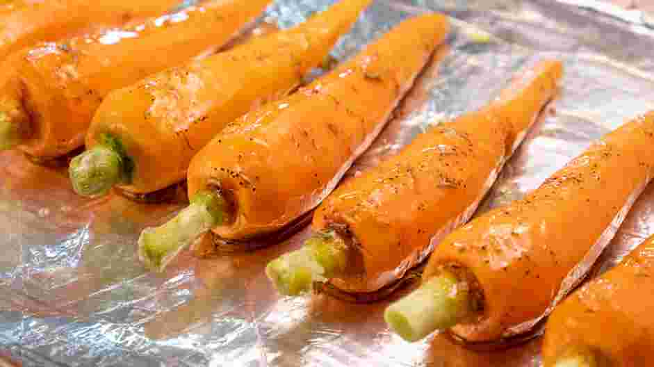 Honey Roasted Carrots Recipe: Pour the mixture over the carrots and roll them around to coat.