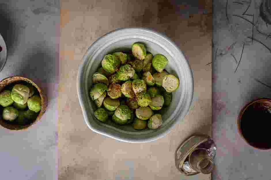 Maple Bacon Brussels Sprouts Recipe: In a large mixing bowl, add the rendered bacon fat, sliced Brussels sprouts, granulated garlic, maple syrup, red pepper flakes, salt and pepper.