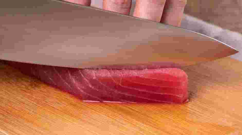 Easy Tuna Nigiri Recipe: On a cutting board with a sushi knife or very sharp knife, thinly slice the fish against the fiber (lines), at a 45&deg; angle.