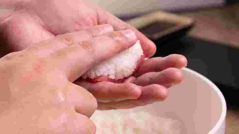 Easy Tuna Nigiri Recipe: Next, place the rice on top of the fish and press down gently with your index finger.