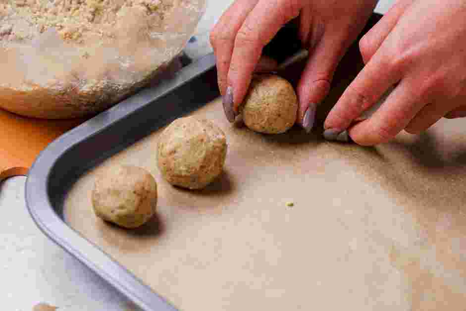 Snowball Cookies Recipe:
Line a baking sheet with parchment paper and scoop 1 tablespoon of cookie dough and roll it in between your palms to create a ball shape.