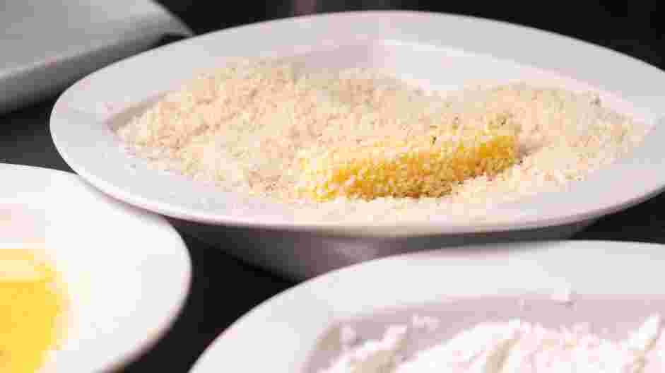 Air Fryer Mozzarella Sticks Recipe:
Roll the string cheese in the seasoned panko and transfer to the prepared sheet pan.