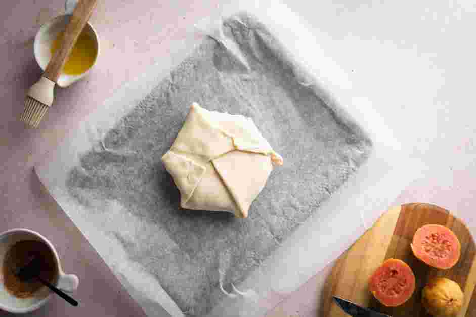 Baked Brie with Jam Recipe:
Fold the dough over the top of the brie, overlapping the folds.