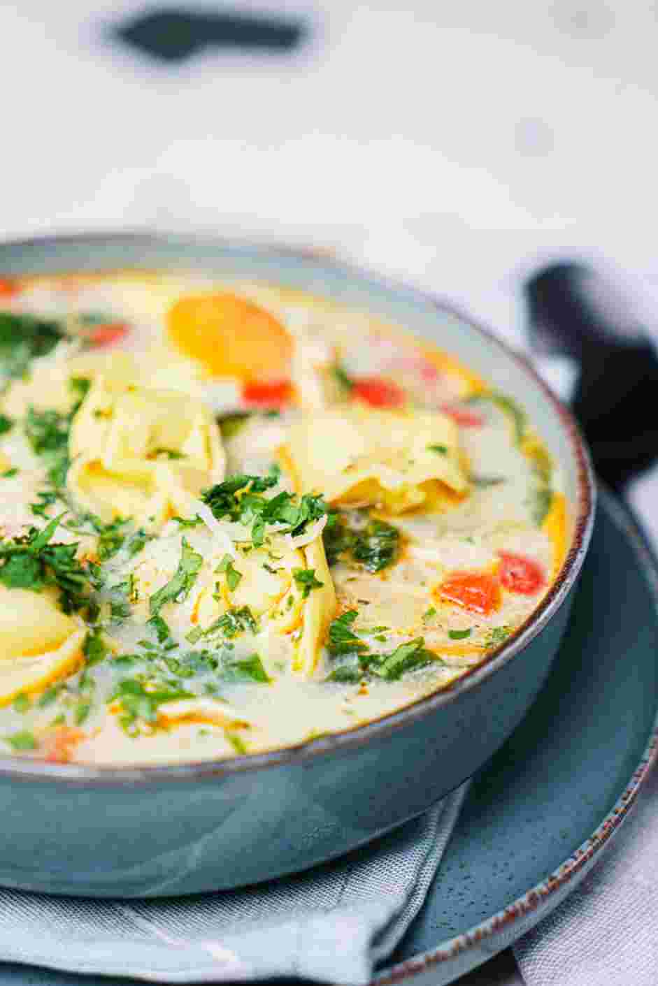 Chicken Tortellini Soup Recipe: Garnish the chicken tortellini soup with Parmesan cheese and parsley before serving.