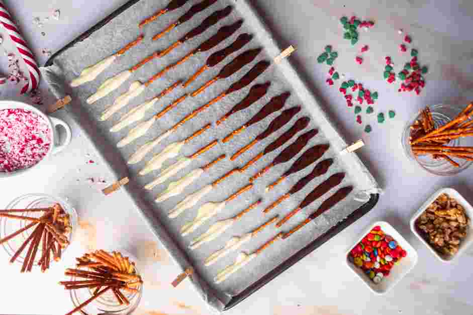 Chocolate Covered Pretzel Rods Recipe: Let the excess chocolate drip off before placing it on the prepared baking sheet.