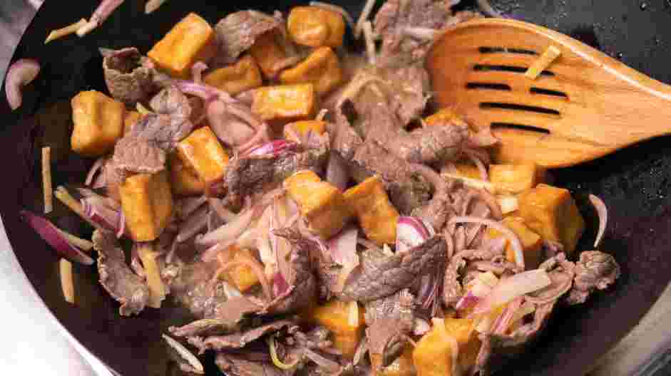 Beef Pad Thai Recipe:
In a cast-iron skillet over medium heat, combine the shallots, tofu, preserved radishes and beef.