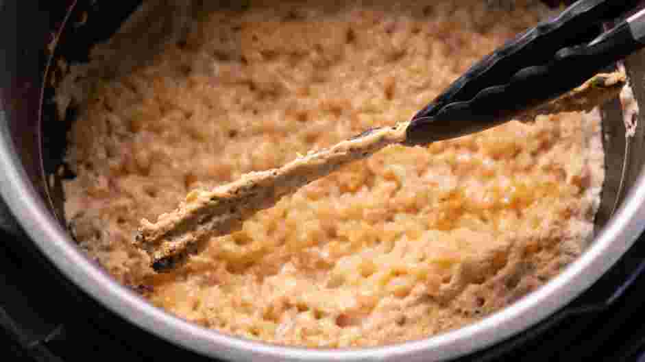 Instant Pot Rice Pudding Recipe: Remove the lid of the Instant Pot and discard the cinnamon stick and the vanilla bean.