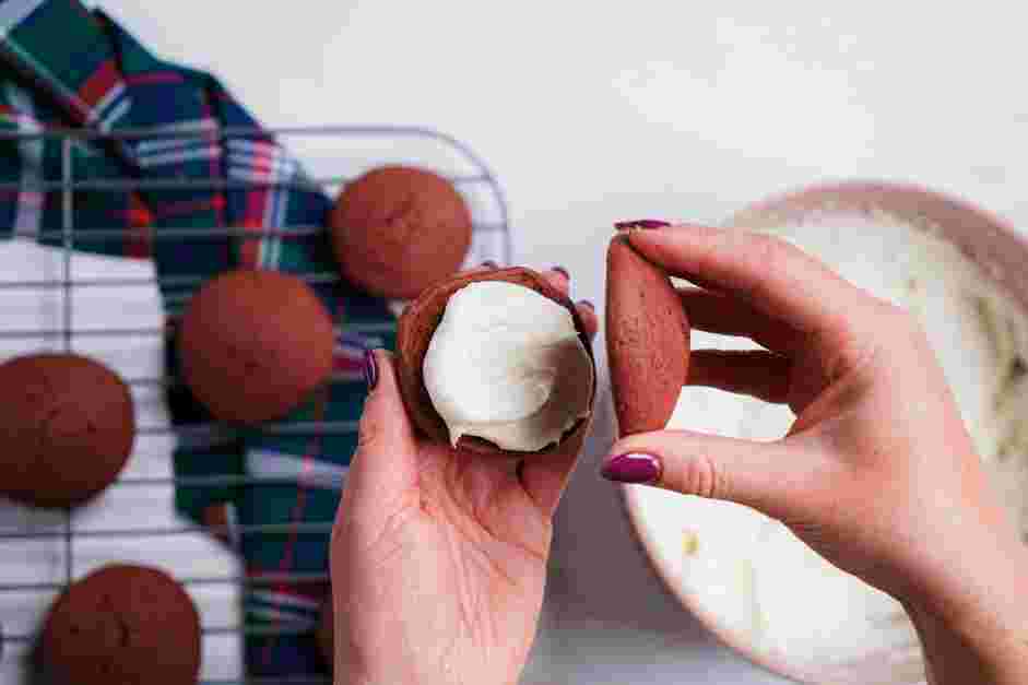 Red Velvet Whoopie Pie Recipe:
To assemble the red velvet whoopie pies, add one to two tablespoons of cream cheese frosting in between two cookies to create a whoopie pie.